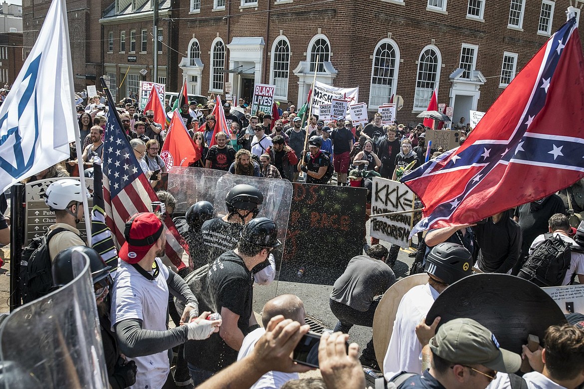 PBS Frontline/ProPublica documentary series “Documenting Hate: Charlottesville” labels protesters in foreground as “white supremacist,” shown here holding “KKK=Holocaust Terrorism” confronting the group in back holding a “Black Lives Matter” sign.
