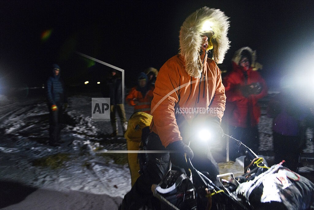 Musher Brent Sass calls for his team to go as he departs the Iditarod Trail Sled Dog Race in Unalakleet, Alaska on Saturday, March 12, 2022. (Marc Lester/Anchorage Daily News via AP)