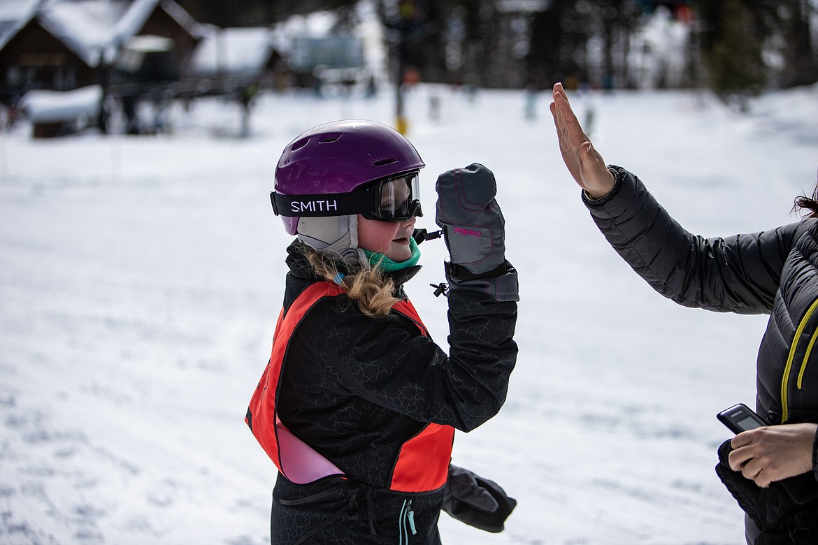 Audrey is greeted by her family at the finish. (JP Edge photo)