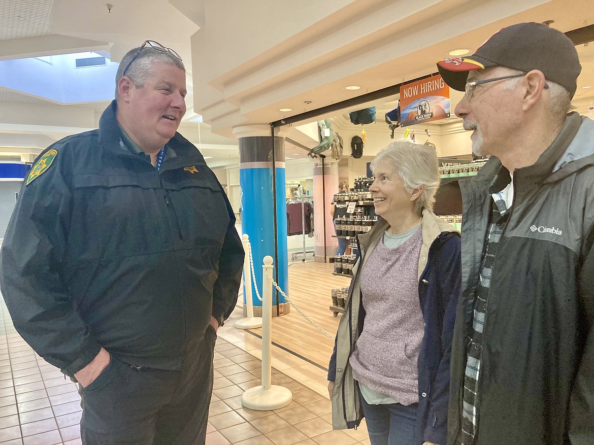 Jail Captain Any Deak chats about problems with staff shortages at the Kootenai County jail with Coeur d'Alene residents Bob and Janet Logan at the Coffee with a Cop event put on by the Kootenai County Sheriff's Office at Macadamia Coffee in the Silver Lake Mall on Tuesday morning. HANNAH NEFF/Press