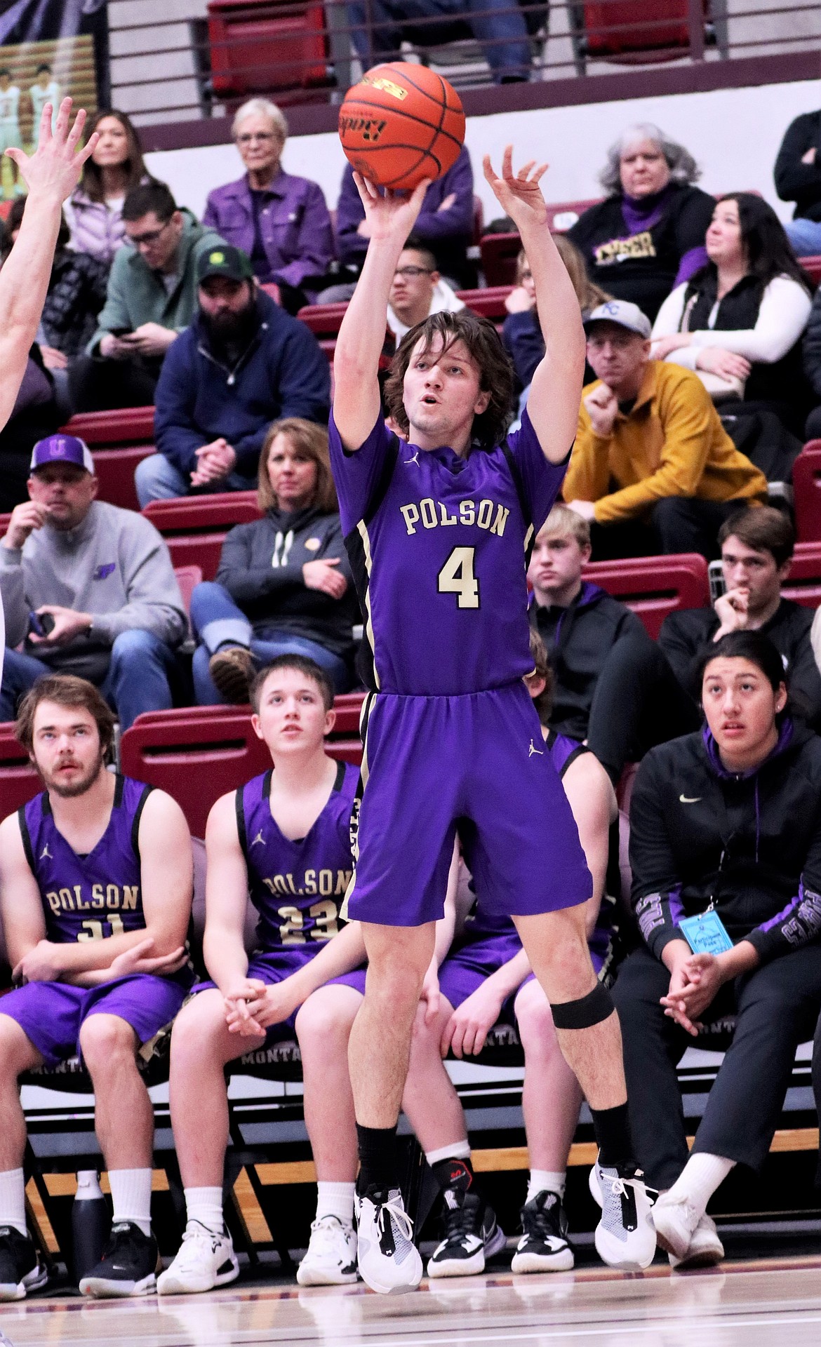 Xavier Fisher puts up a 3-pointer in front of the Polson bench at Dahlberg Arena in Missoula. (Courtesy of Niki Graham)