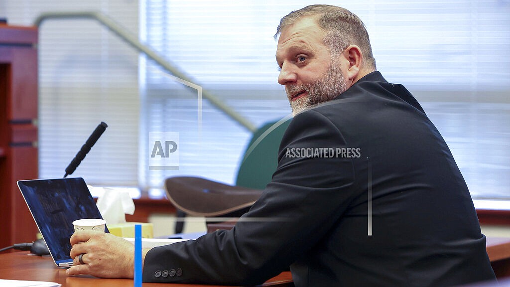 Ammon Bundy glances toward the prosecution table during a pause in his trial to clarify a line of questioning with the jury dismissed in Ada County Magistrate Judge Kim Dale's courtroom Tuesday, March 15, 2022, in Boise, Idaho. A major Boise hospital went on lockdown for about an hour Tuesday after far-right activist Bundy urged supporters to go the facility in protest of a child protection case involving one of his family friends. Bundy, who is well-known for participating in armed standoffs with law enforcement, was arrested on Saturday on a misdemeanor trespassing charge after he protested at a different hospital where he believed the baby was being treated. (Darin Oswald/Idaho Statesman via AP)