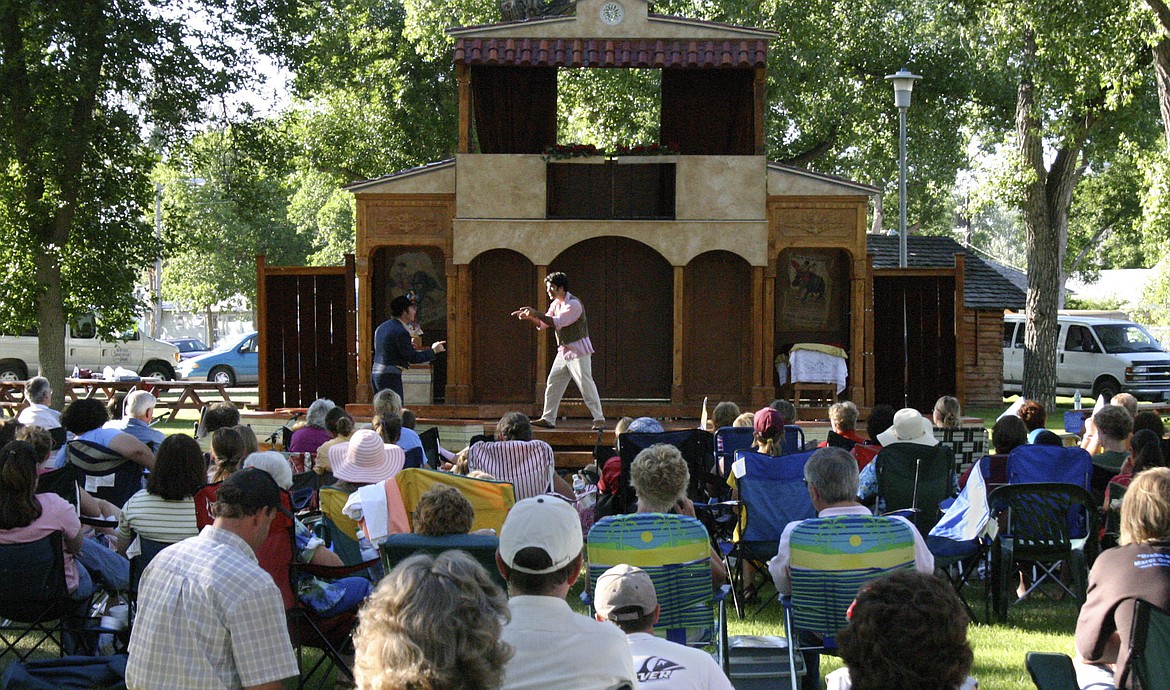 FILE - Residents of Fort Benton, Mont., watch the Montana Shakespeare in the Parks theater company performance of "The Taming of the Shrew," on July 20, 2005. For half a century, Montana Shakespeare in the Parks has been connecting people across the state and beyond to the fabled playwright. (AP Photo/Sarah Cooke, File)