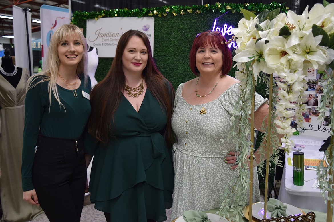 Samantha Candela, Ashley Meadows and Sandy Hanson of Enchanting Gown Bridal Boutique celebrate the annual local business expo organized by the Moses Lake Chamber of Commerce at the Grant County Fairgrounds on Tuesday.