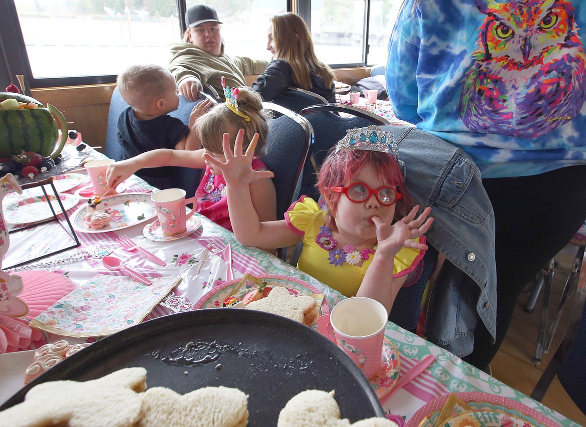 Harper Beare, 5, enjoys some of the treats for her Fancy Nancy tea party on a Lake Coeur d'Alene Cruise boat Wednesday.