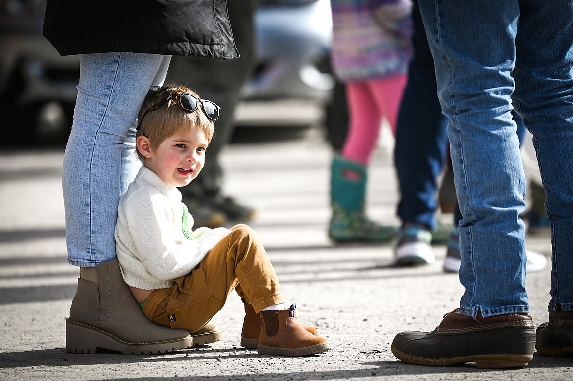 A child takes a seat before the start of the St. Patrick's Day Parade along Main Street in Kalispell on Thursday, March 17. (Casey Kreider/Daily Inter Lake)