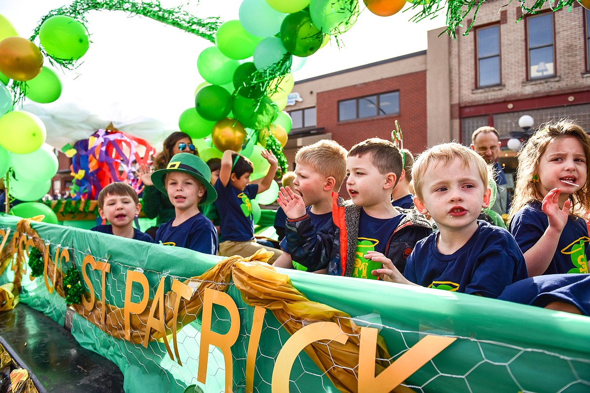 Children from St. Matthew's Catholic School wave from a float during the St. Patrick's Day Parade in Kalispell on Thursday, March 17. (Casey Kreider/Daily Inter Lake)