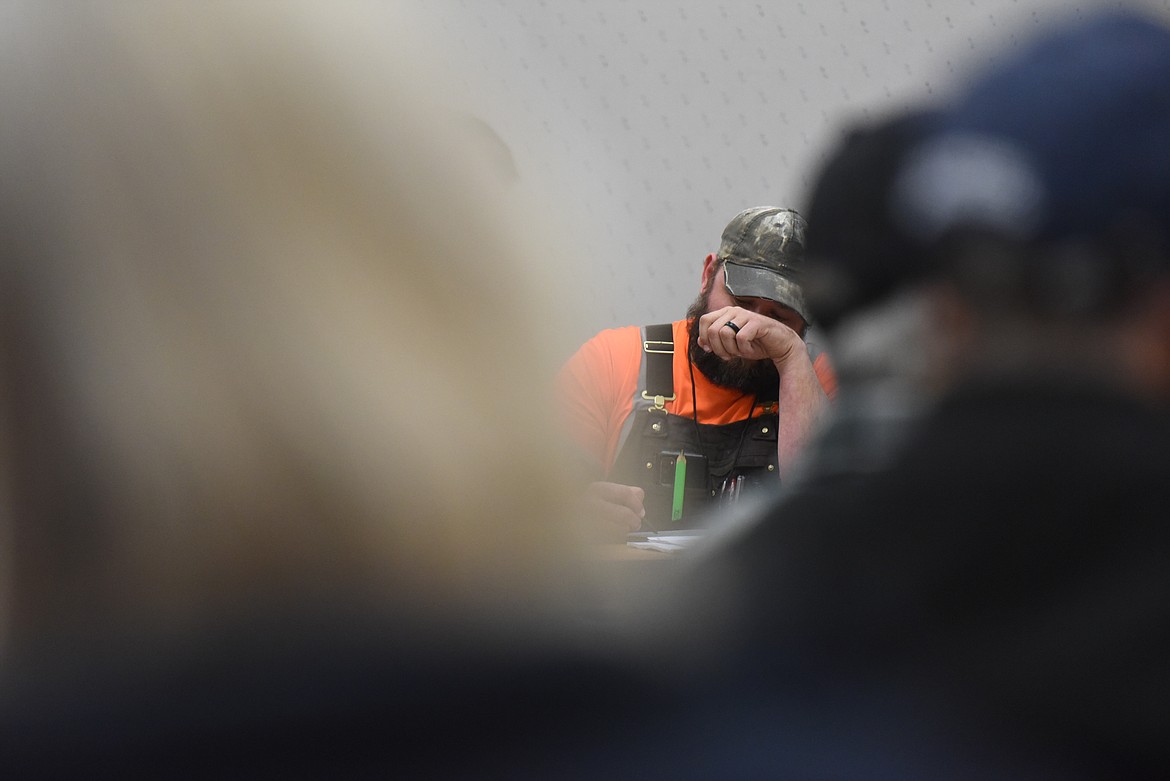 Levi Thompson of Thompson Contracting Inc. takes notes during a March 15 public meeting in Libby. (Derrick Perkins/The Western News)