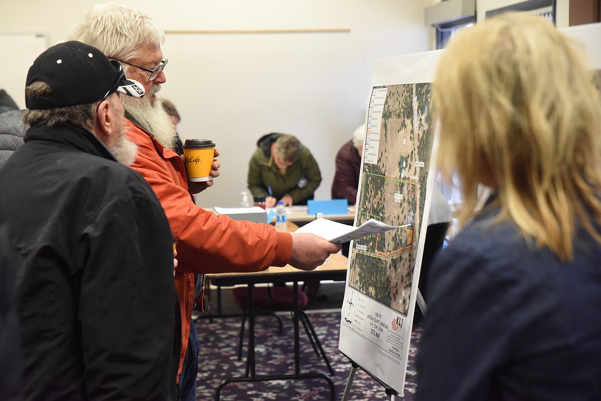 Residents look at maps of a proposed gravel pit near Farm to Market Road south of Libby during a March 15 meeting. (Derrick Perkins/The Western News)