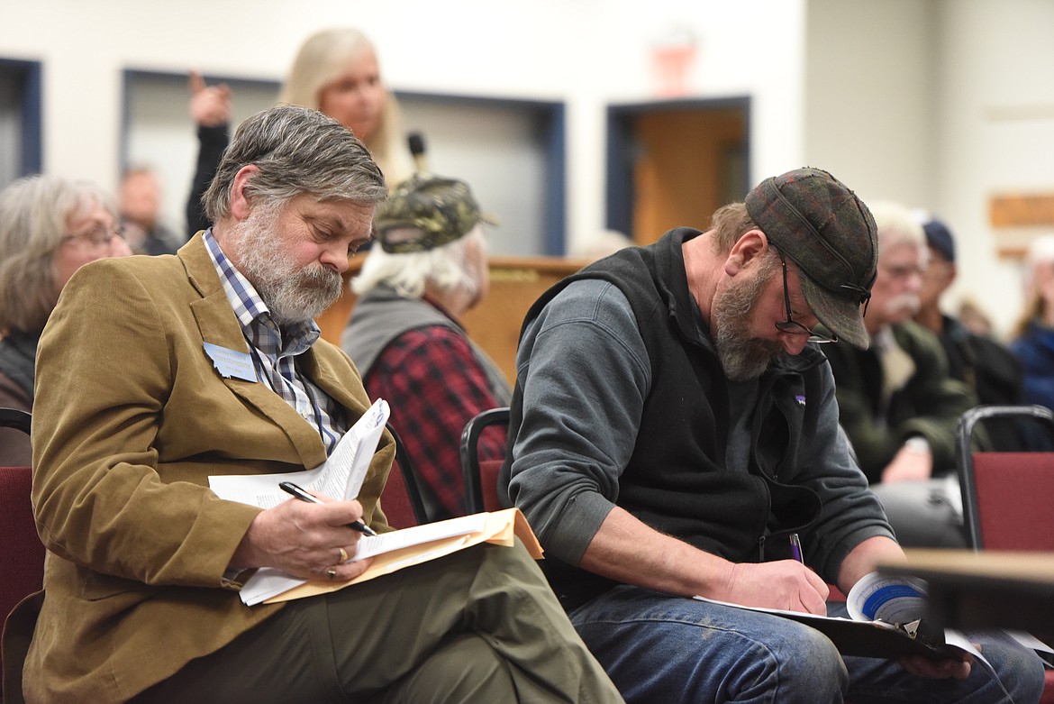 State Rep. Steve Gunderson, left, listens at a Department of Environmental Quality meeting on Thompson Contracting Inc.'s proposed gravel pit on Farm to Market Road. Gunderson lobbied Levi Thompson, vice president of the firm, to reconsider the location of the facility. (Derrick Perkins/The Western News)