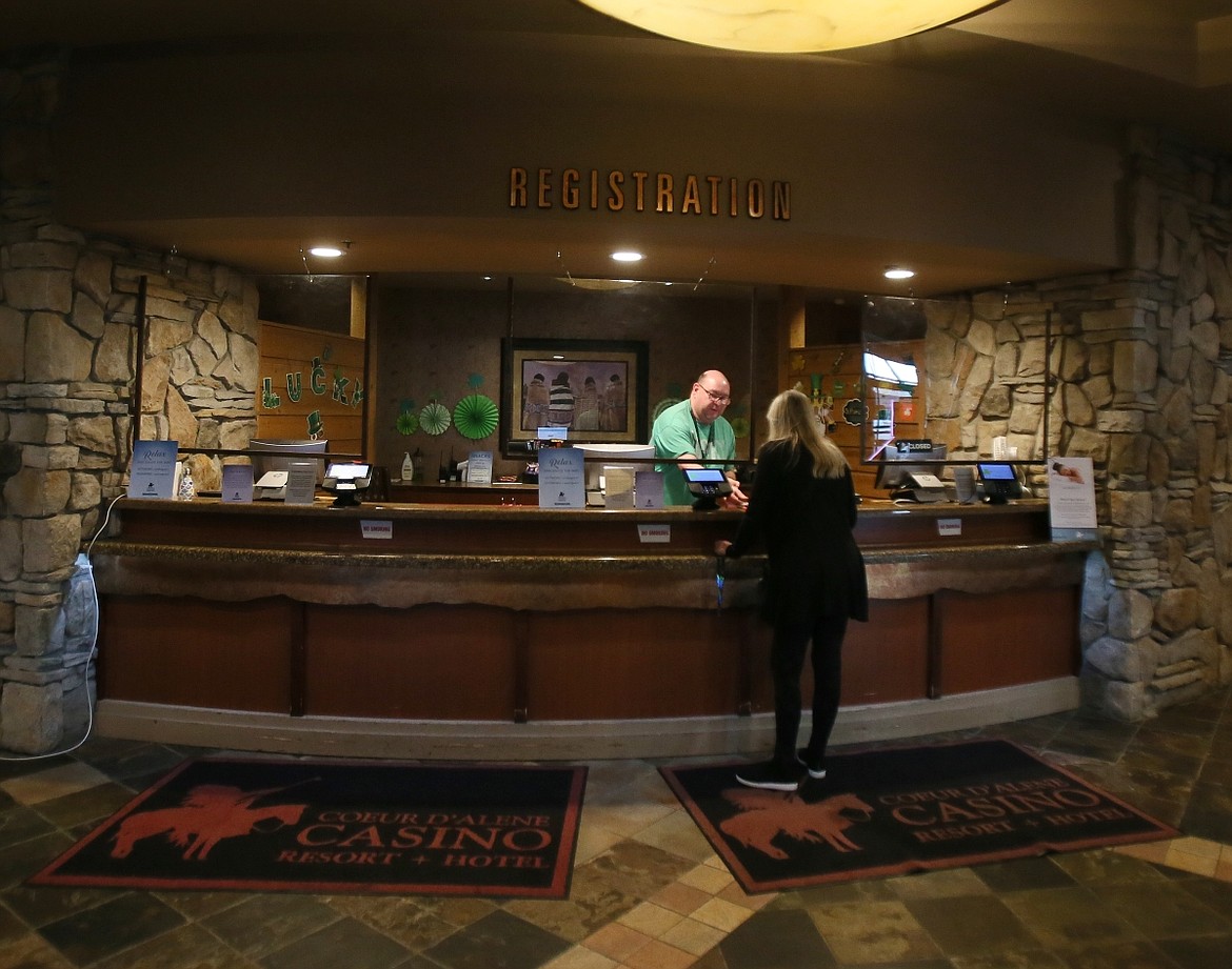 Front desk agent Eric Mosher helps a Coeur d'Alene Casino guest on Thursday.