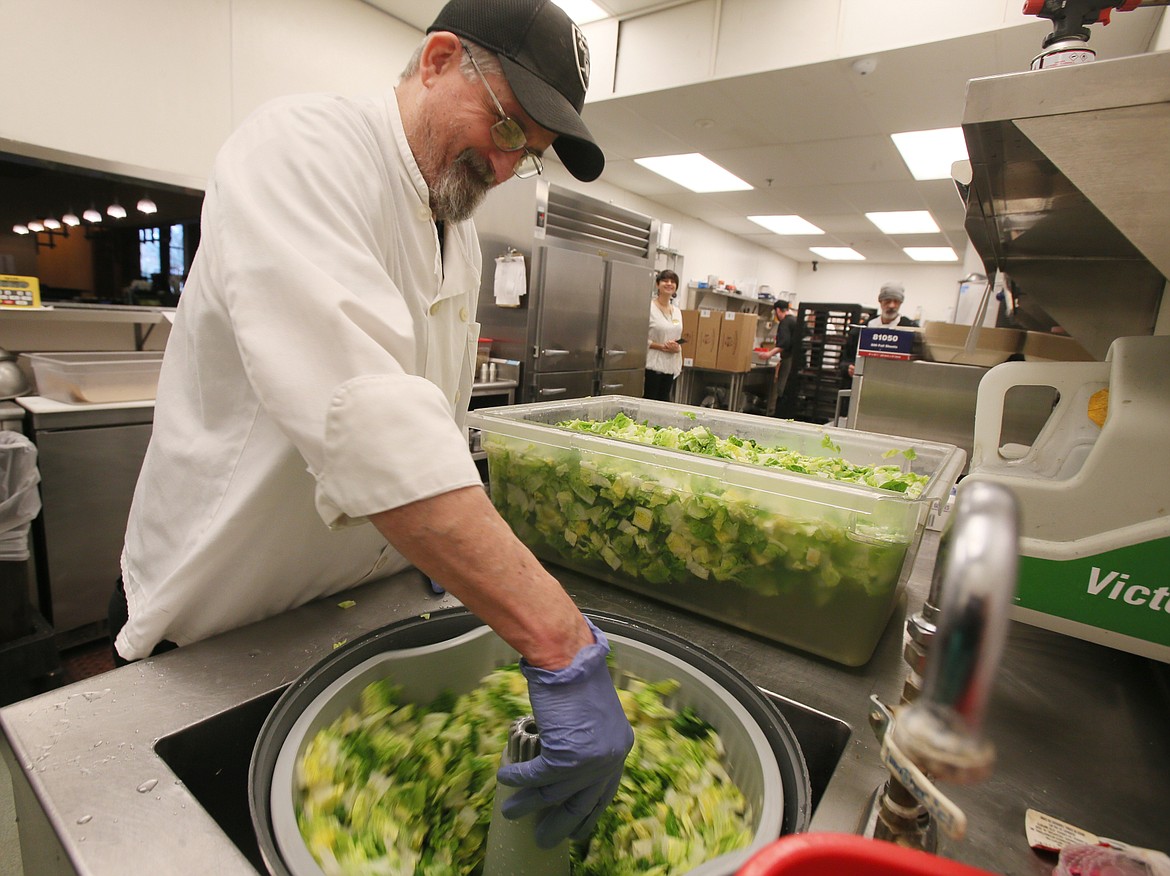 Prep cook Roger Canty spins freshly chopped salad lettuce before the Chinook Steak, Pasta and Spirits restaurant opens Thursday afternoon.
