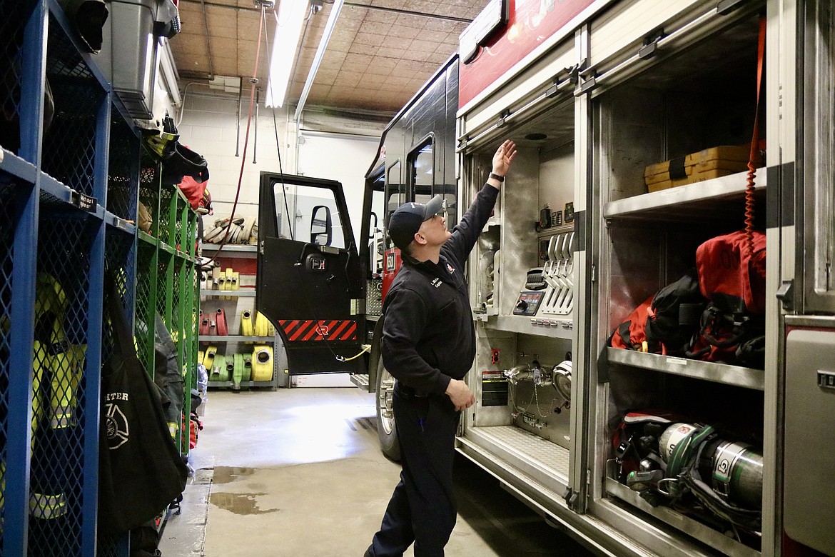 Northern Lakes Fire Protection District fire captain Luke Michael, serving as battalion chief because of staffing shortages, checks an engine at the Hayden station on Wednesday. HANNAH NEFF/Press