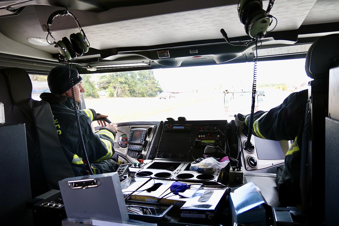 On left, Northern Lakes Fire Protection District firefighter Tyler Turrell drives an engine to respond to a fire alert call on Wednesday. HANNAH NEFF/Press