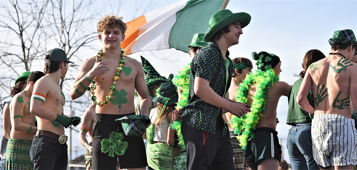 Ronan High School wrestler Landon Bishop gives the thumbs-up aboard the Fighting Irish float. (Scot Heisel/Lake County Leader)