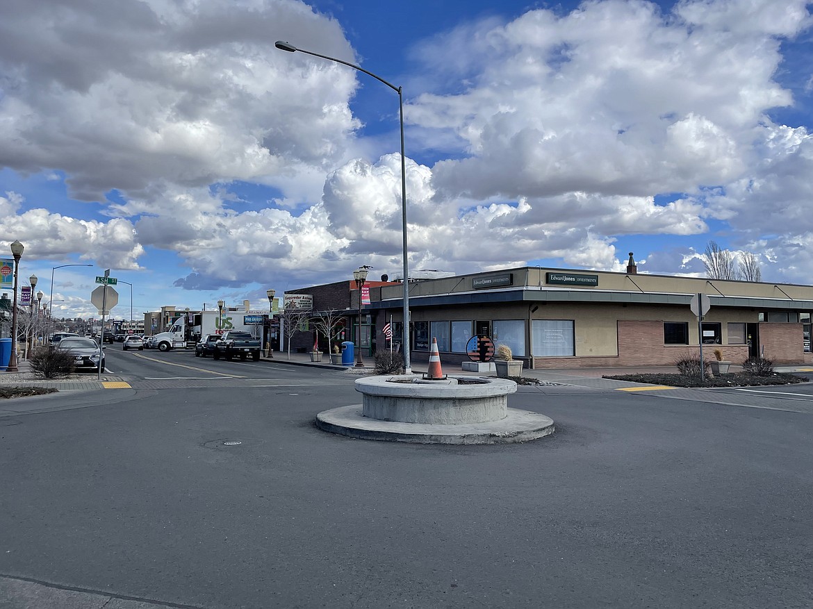 The clockless intersection of W. Third Avenue and Ash Street in downtown Moses Lake Wednesday morning. City crews removed the clock, which normally sits in the center of the intersection occupied by an orange traffic cone in this photo, in order to repaint and repair it.