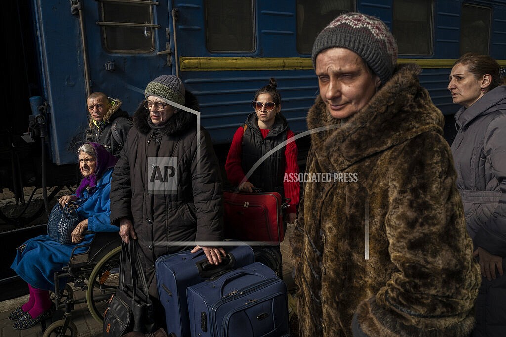 Ukrainians escaping from the besieged city of Mariupol along with other passengers from Zaporizhzhia arrive at Lviv, western Ukraine, on Sunday, March 20, 2022. (AP Photo/Bernat Armangue)