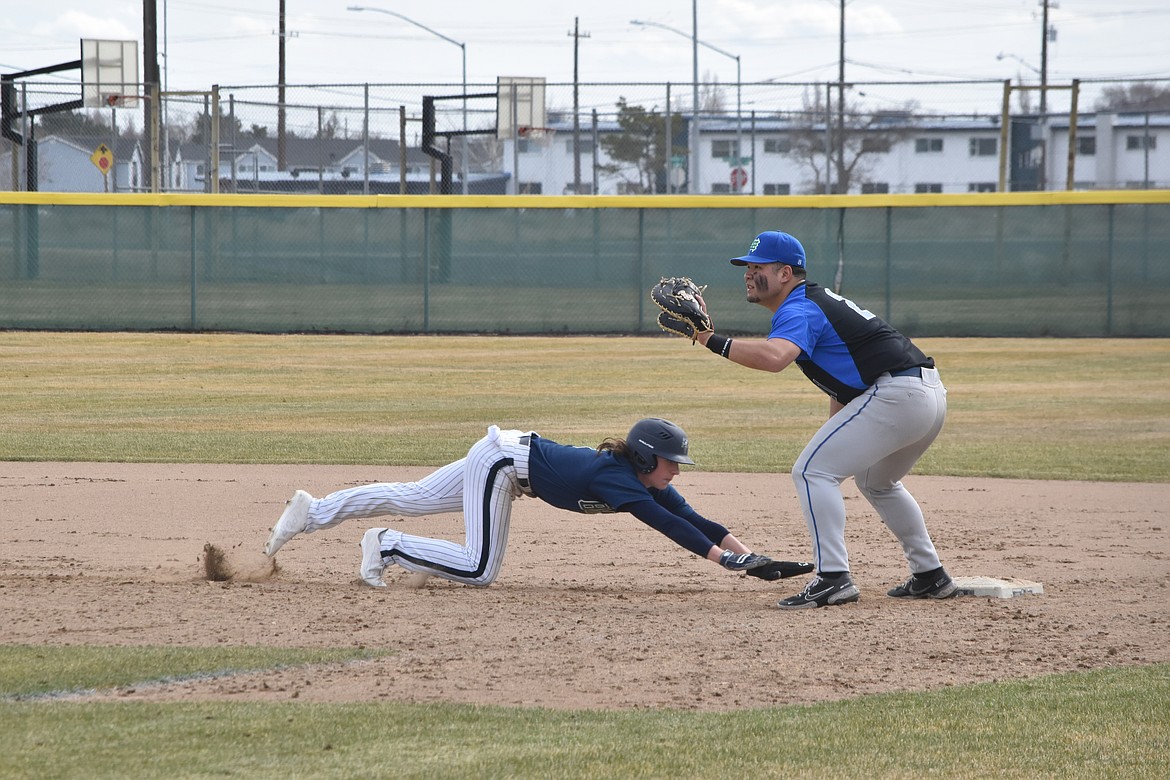 Big Bend Baseball player Kai Jones (1) dives to get back to first base before the first baseman can get him out during the double header against Edmonds College on March 18.