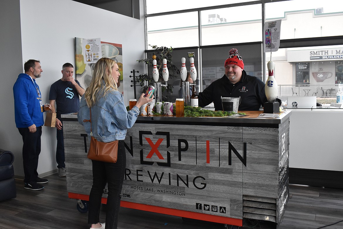 Ten Pin Brewing representative John Wagner talks to Ephrata resident Jessika Tempel about their selections at Brews & Tunes on March 19.