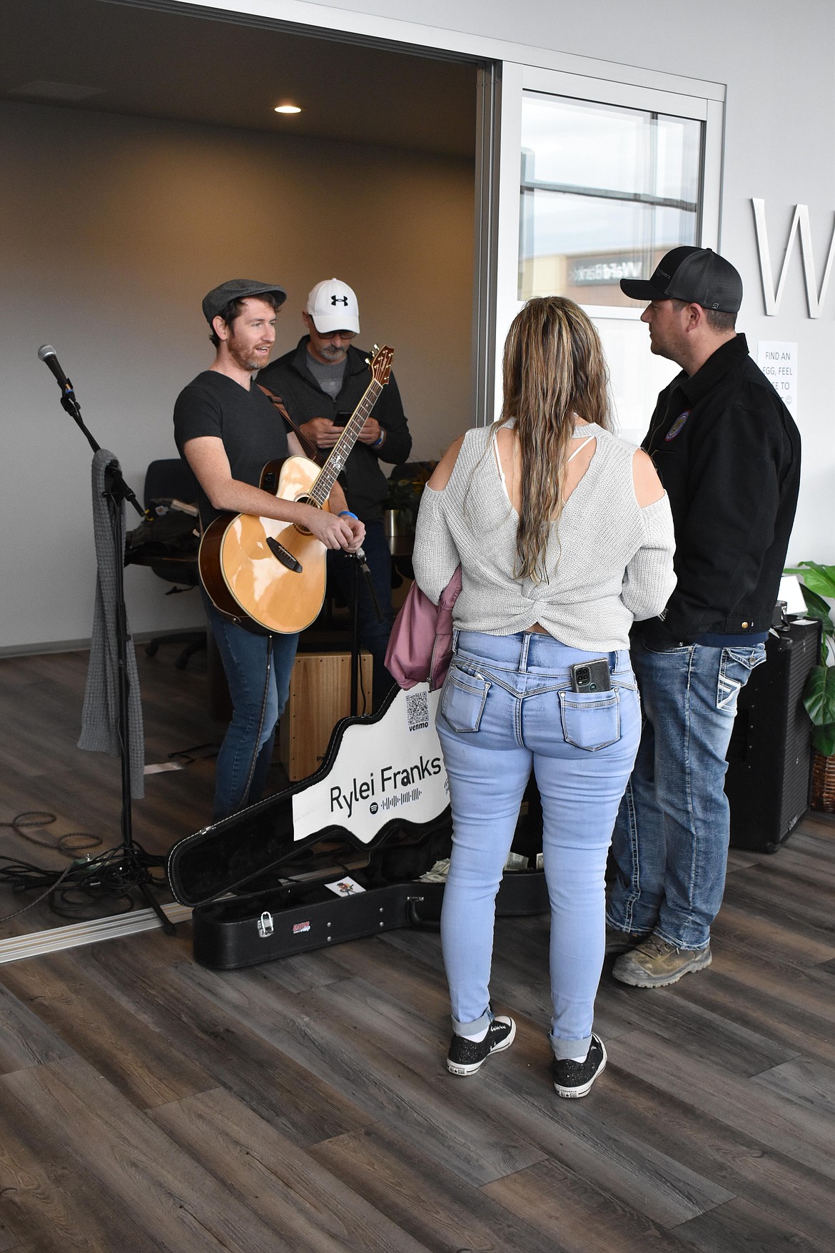 Community members got to mingle with some of the bands and musicians at Brews & Tunes March 19. Above, a couple talk to Rylei Franks who was performing inside Windermere K2 Realty.