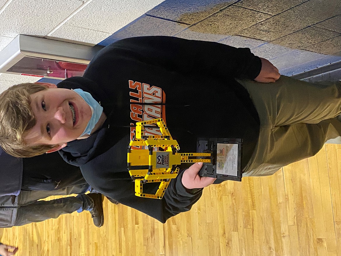 Thirteen year old Post Falls Middle School student Eli Vandivier holding his trophy for robotics design at the recent First Lego League competition. Vandivier excells at numerous hobbies and interests and was recently chosen to attend Envision's Junior National Young Leaders Conference in June.