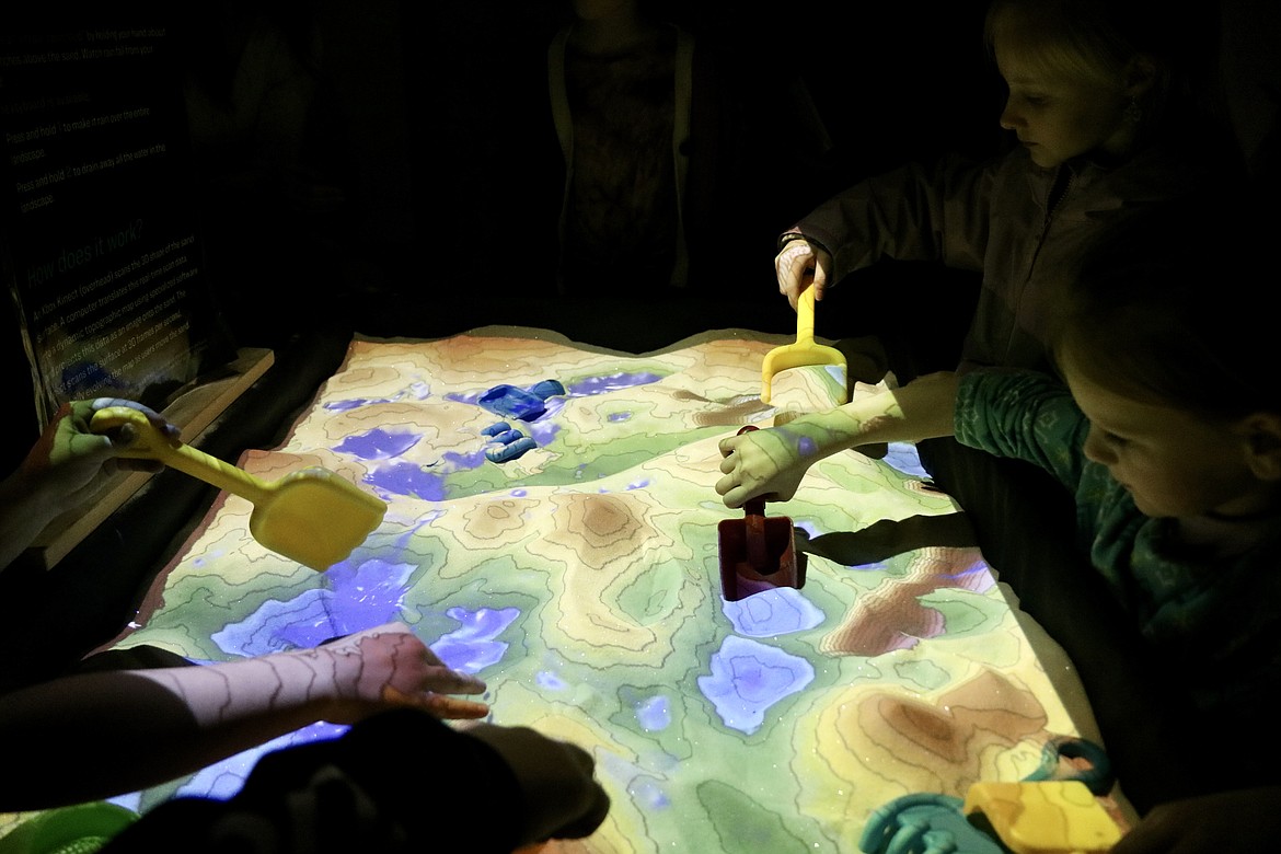 Students play with the augmented reality sandbox at STEAM night on March 17 at Prairie View Elementary School in Post Falls. HANNAH NEFF/Press