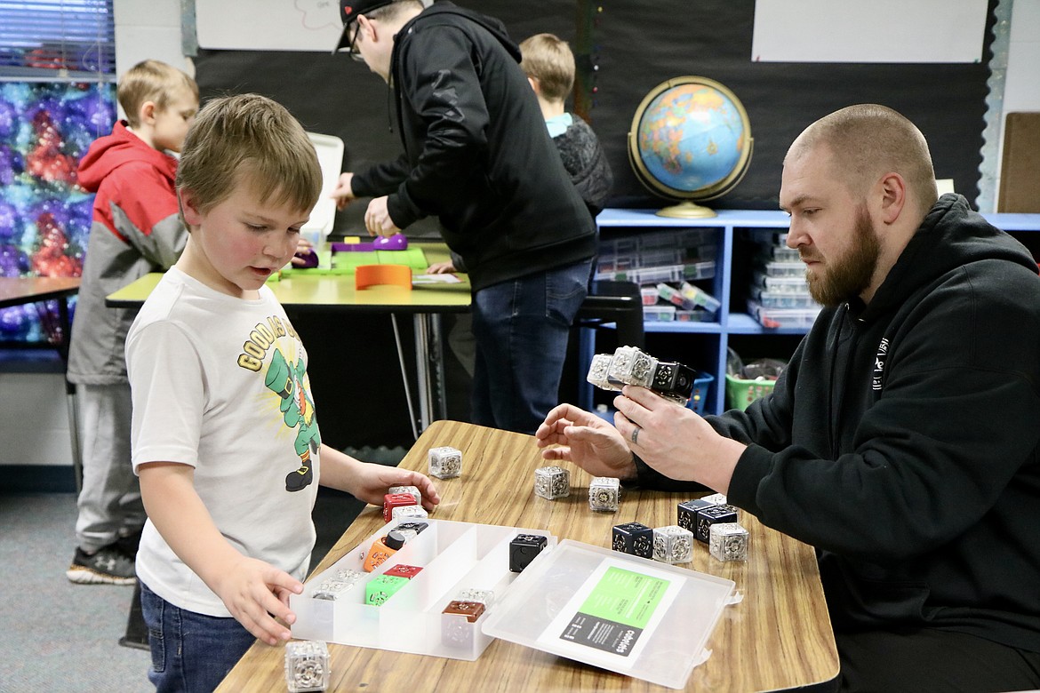 Brian Oliver and son Jax play with block robots at STEAM night on March 17 at Prairie View Elementary School in Post Falls. HANNAH NEFF/Press