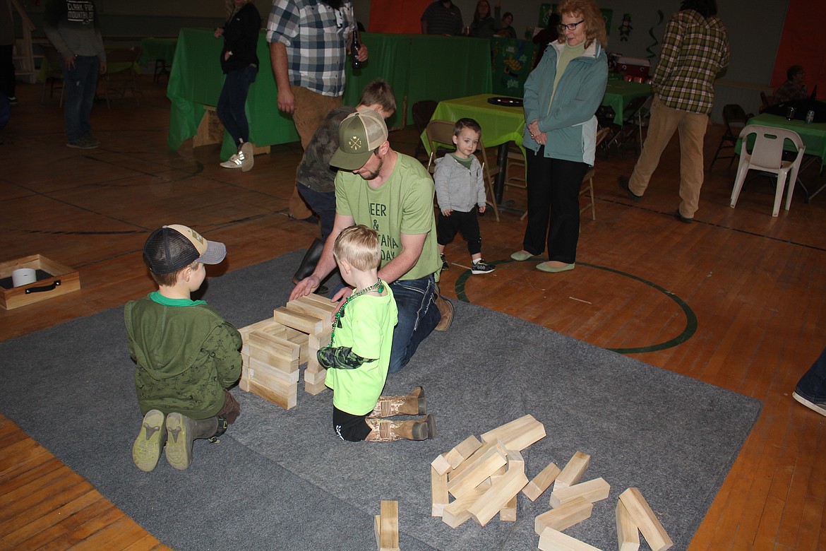 Giant Jenga was one of the family games at the Indoor Beer Garden Party on St. Patrick’s Day. The event was a fundraiser by the Mineral County Rec Club as one of their first projects is to revive the ski club to provide transportation for kids to Lookout Pass from Alberton through Haugan. It was well received and became the unofficial social gathering after a long winter. (Monte Turner/Mineral Independent)