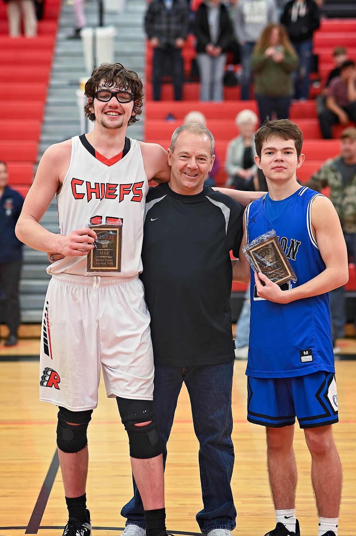 Ronan's Payton Cates and Mission's Zoran LaFrombois sandwich contest organizer Steve Woll as they pose with their co-MVP plaques. (Courtesy of Christa Umphrey, Forward Photography)