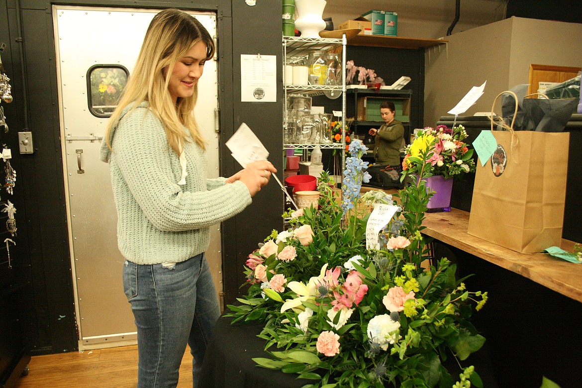 Desert Rose Floral Designs owner Melody Anguiano adds to a floral arrangement at her shop in Othello. Desert Rose has grown from a floral and gift shop, adding a clothing and jewelry boutique and, sometime this year, a cafe.