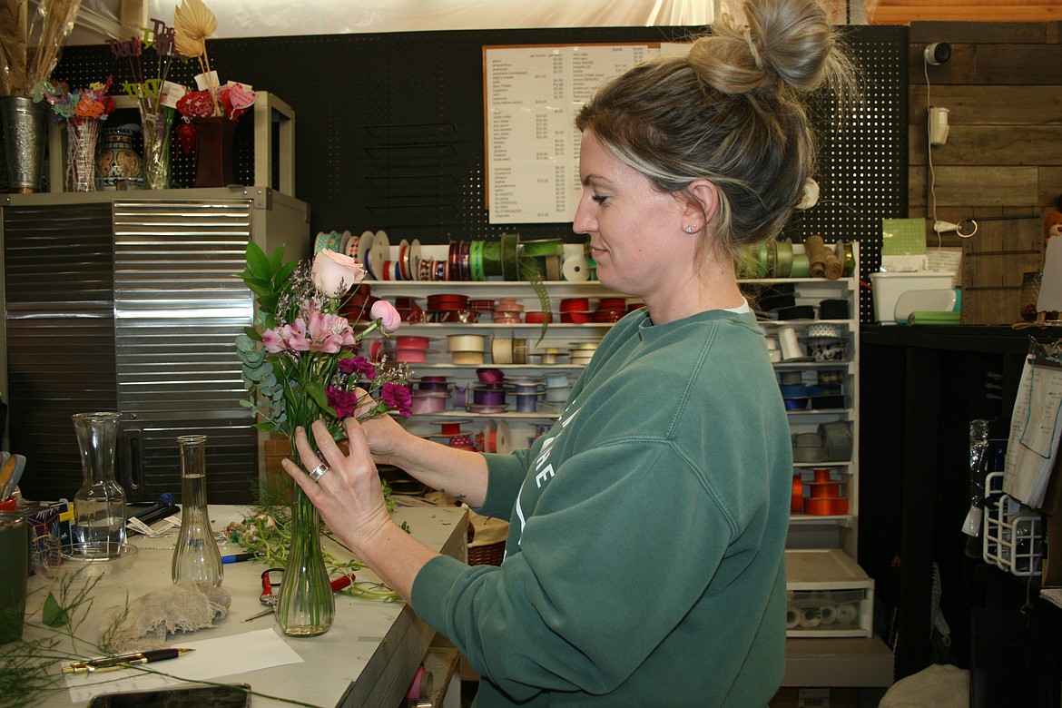 Kiley Willis of Desert Rose Floral Designs, Othello, works on a bouquet. Owner Melody Anguiano said she wants Desert Rose to be a place where people hang out.