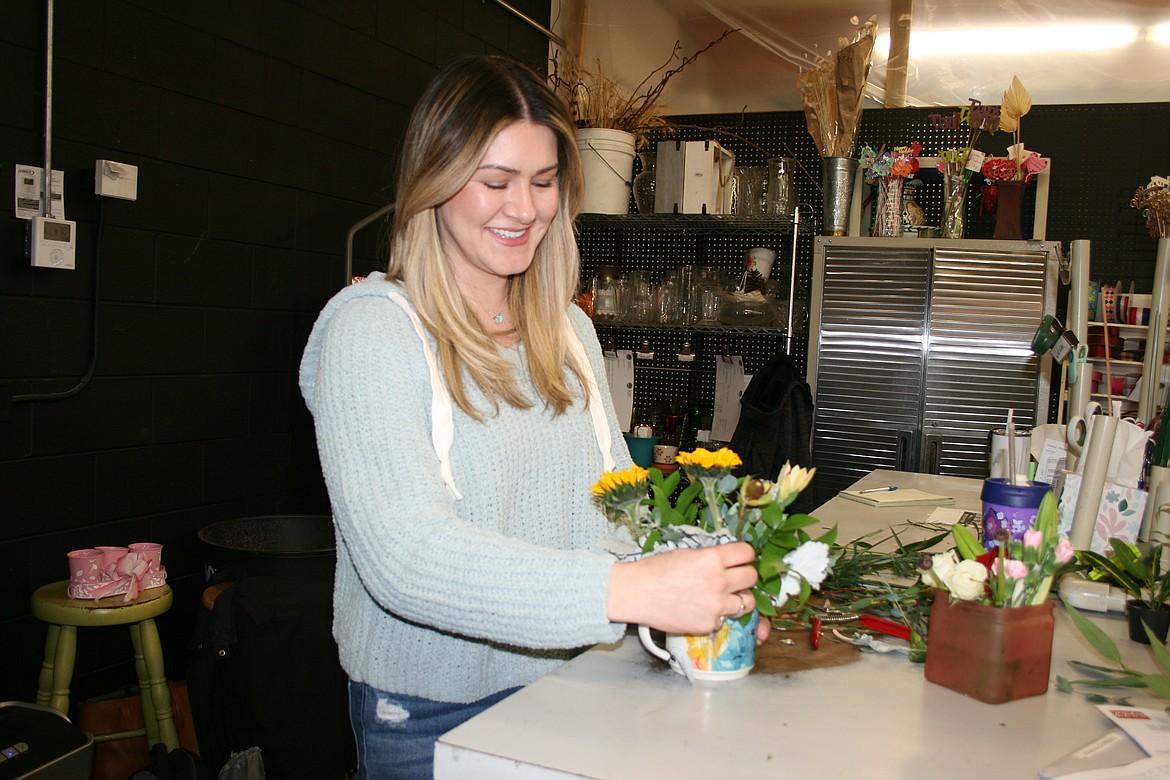 Desert Rose Floral Designs owner Melody Anguiano works on a bouquet. She said customers have told her that Desert Rose is a go-to spot to take a break.