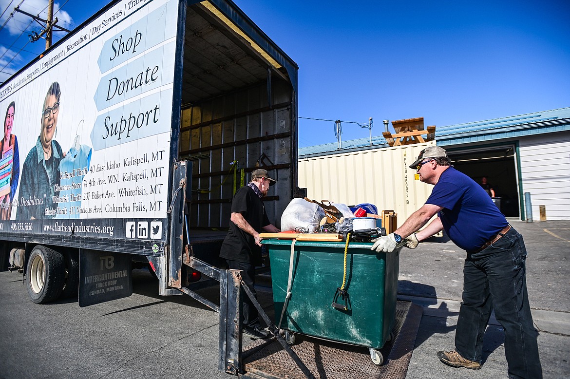 Two workers load donations into a truck for transport outside Flathead Industries in Kalispell on Wednesday, Sept. 29. (Casey Kreider/Daily Inter Lake)