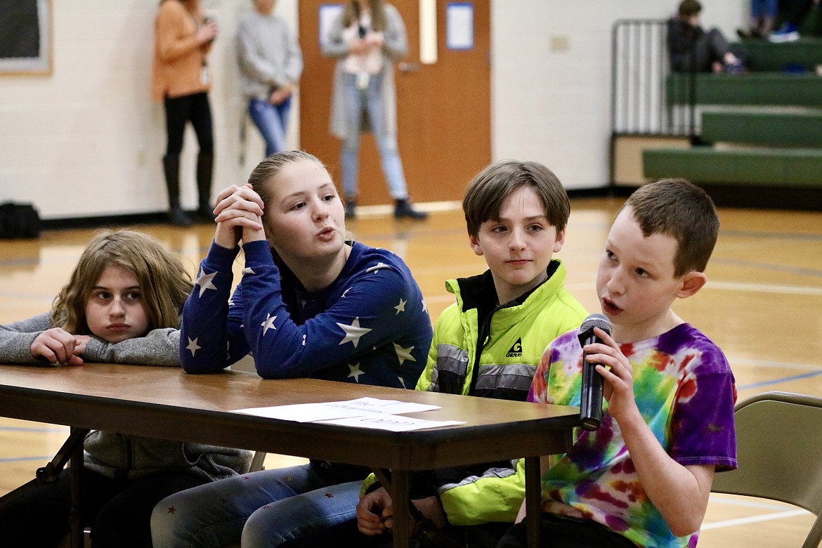 On right, fifth-grader Logan Shaw answers a question during Battle of the Books, a reading comprehension bowl, at Atlas Elementary School on Monday. Other teammates from left include Annalise Hunt, Ava Rusche and Jacob Smith. HANNAH NEFF/Press