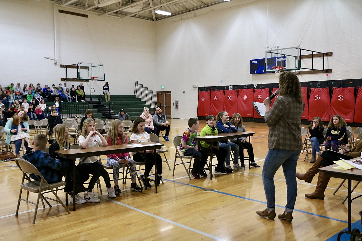 Atlas Elementary School librarian Sara Grimm facilitates the winning fourth and fifth grade teams in a competition for the school-wide championship during the Battle of the Books reading comprehension bowl on Monday. HANNAH NEFF/Press