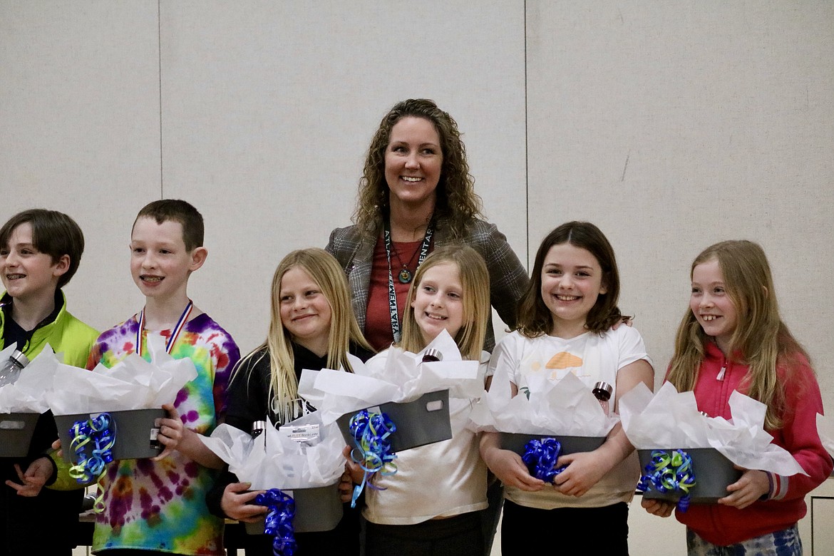 Atlas Elementary School librarian Sara Grimm stands with some members of the winning fourth and fifth grade teams after the Battle of the Books on Monday. Students from left include Jacob Smith, Logan Shaw, Aubrey Hanson, Savannah Preece, Halle Hatfield and Arianna Leferin. HANNAH NEFF/Press