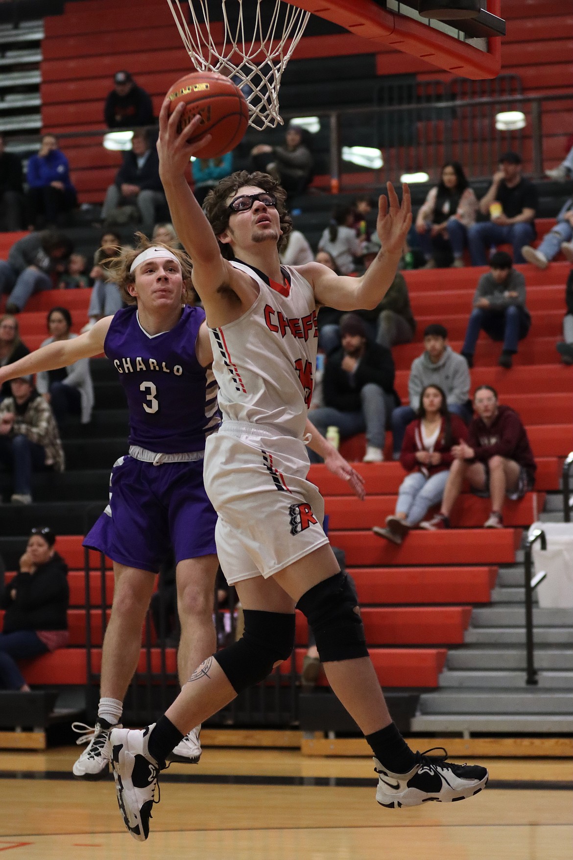 Ronan's Payton Cates puts up a shot in front of Keaton Piedalue of Charlo. (Courtesy of Niki Graham)