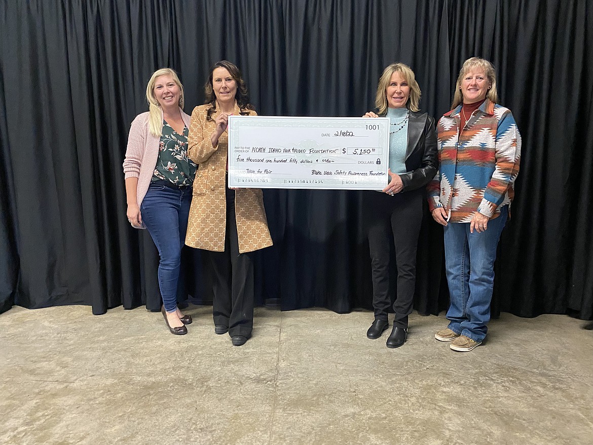 The North Idaho Fair & Rodeo Foundation accepted a check from the Blake Webb Safety Awareness Foundation (BWSAF) in the amount of $5,150 for purchase of a table to be placed on the fairground property for additional seating during the annual fair and events throughout the year. The BWSAF chose the fair property to honor their son Blake Webb, who died in a motocross accident in 2007. The foundation purchases safety awareness equipment and provides education to tracks throughout the country. Additionally, they have given to families experiencing hardships and charitable organizations from proceeds raised at their rummage sale held annually. Under the recently launched "Bench and Table Program," Co-Chaired by Gayle Stegmann and Rachel Peters, donors can purchase a bench or table and have their business or individual’s names noted. For an additional $150, a plaque remembering a loved one or the like can be placed on the equipment. You may also choose from one of three different locations at the fairgrounds. We are seeking additional donors. For more information or to download a brochure, checkout the foundation webpage at www.kcfairgrounds.org, Rachel Peters at 208-661-7971 or Gayle Stegmann at 509-994-6098. From left: Alexcia Jordon, fair manager; Laurice Webb, director-BWSAF; Gayle Stegmann and Rachel Peters, board members and program directors.