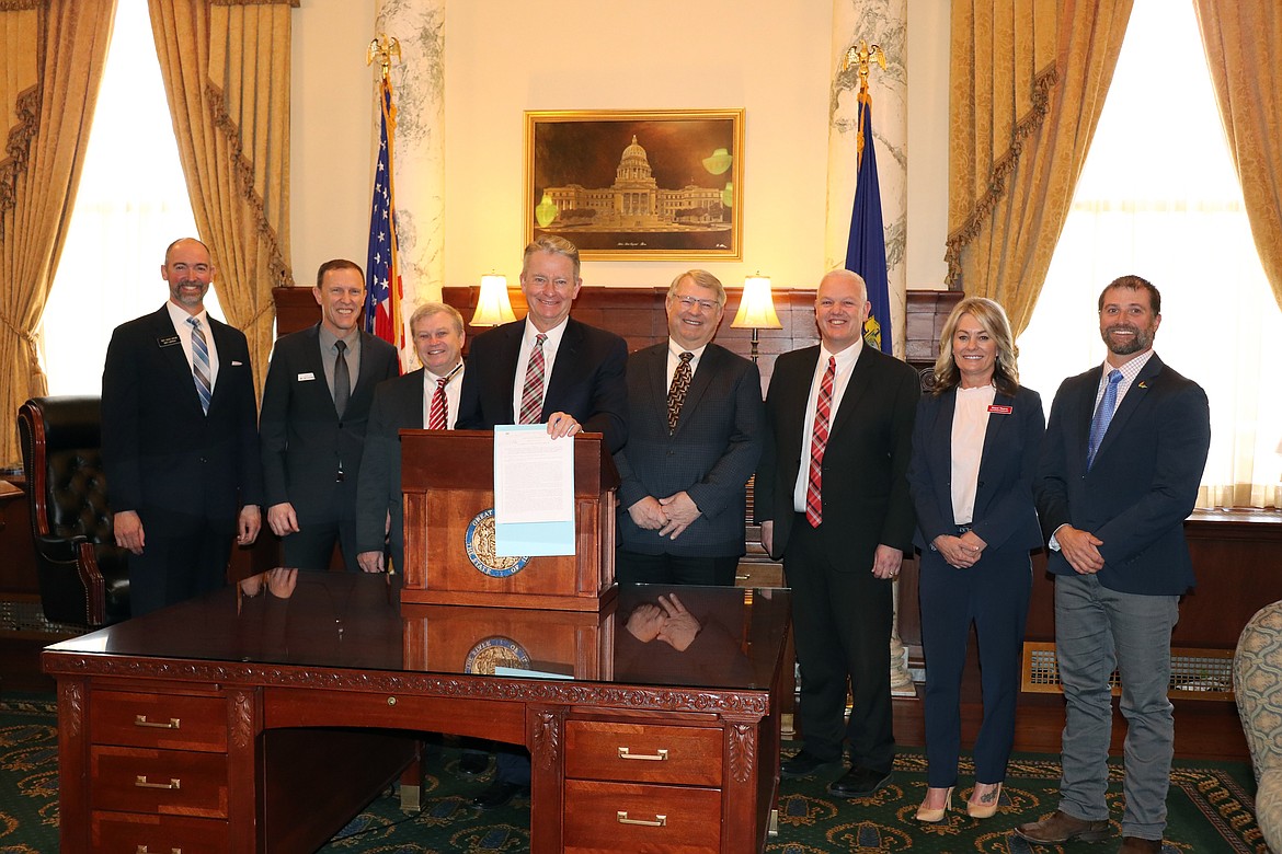 Legislators and state officials join Idaho Gov. Brad Little at the signing of House Bill 588 which authorizes wildland firefighters to receive hazard pay while working in dangerous conditions.