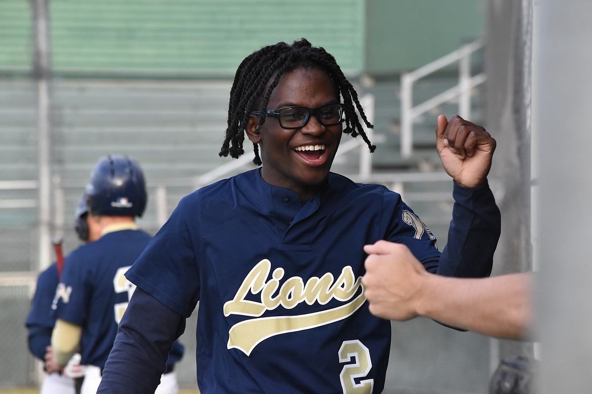 MLCA/CCS junior Jeff Boorman smiles and knuckles his teammates after scoring a run. While the Lions may have lost, the team looked happy to be representing their school on the diamond.