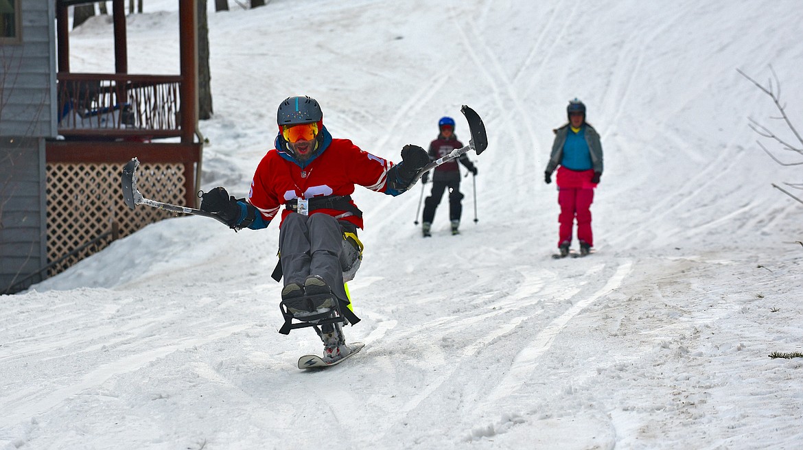 Lucas Stacy, Everett Stacy and Kim Givler participate in DREAM Adaptive's Shred-a-thon Saturday. (Julie Engler/Whitefish Pilot)