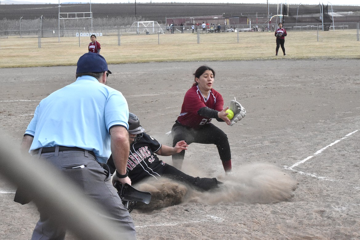 A Wahluke High School fastpitch athlete (19) slides into home base as a Toppenish player attempts to tag her during the doubleheader on March 26 at Wahluke High School. Spoiler: she was safe.