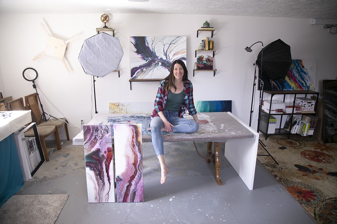Sara Taylor sits on the table in her home studio in Sandpoint. After delivering two premature twins in the Level IV Neonatal Intensive Care Unit at Providence Sacred Heart Medical Center in Spokane, Taylor is donating original artwork and print proceeds to the special care unit.