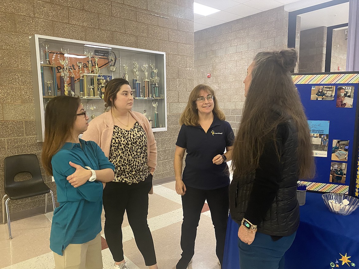 From left: Project Search intern Tricia Powell, vocational transition teacher Abbie Waters and Project Search instructor Theresa Moran discuss the program with a parent at the Transitions Expo held at Post Falls High School March 22.