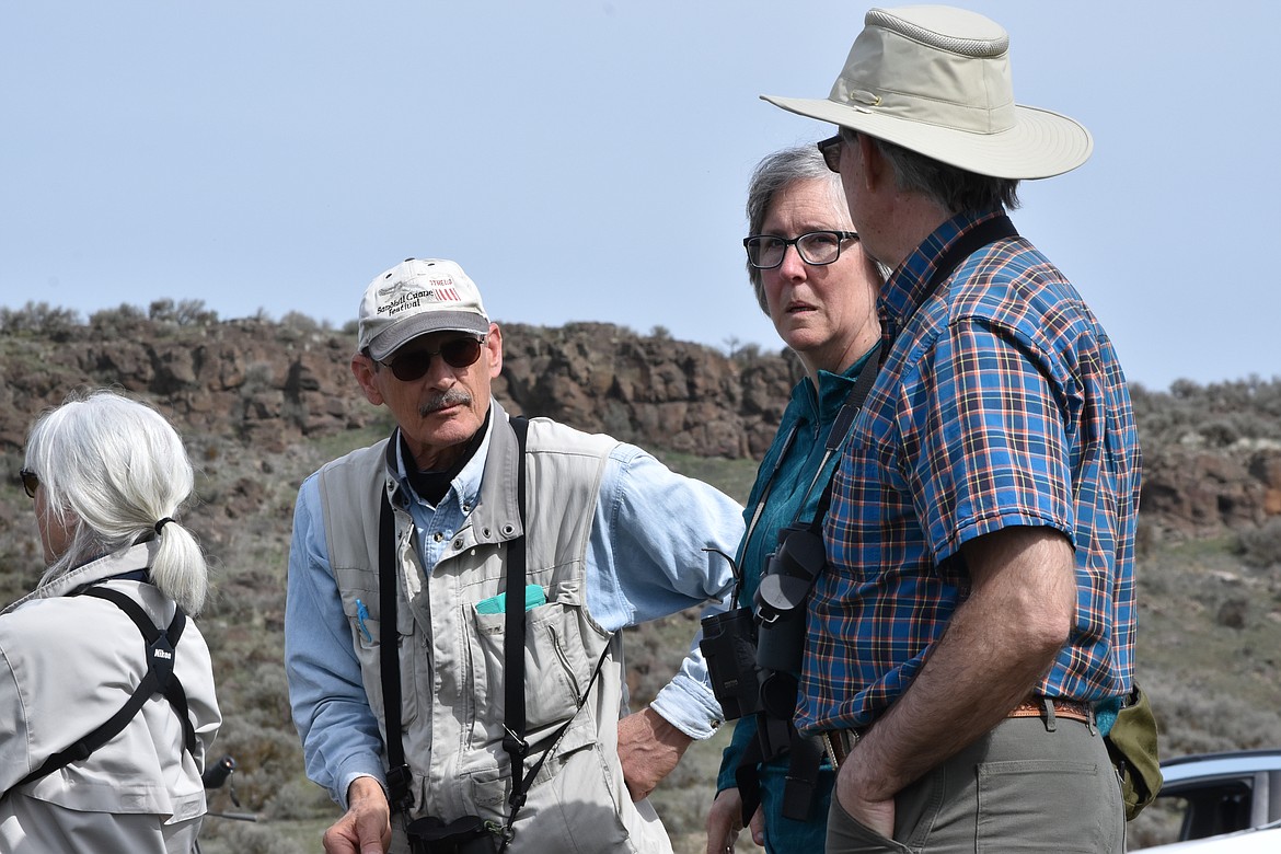 Biologist Randy Hill (left) speaks with visitors at Marsh Unit 1 about the wildlife of the area on March 26.