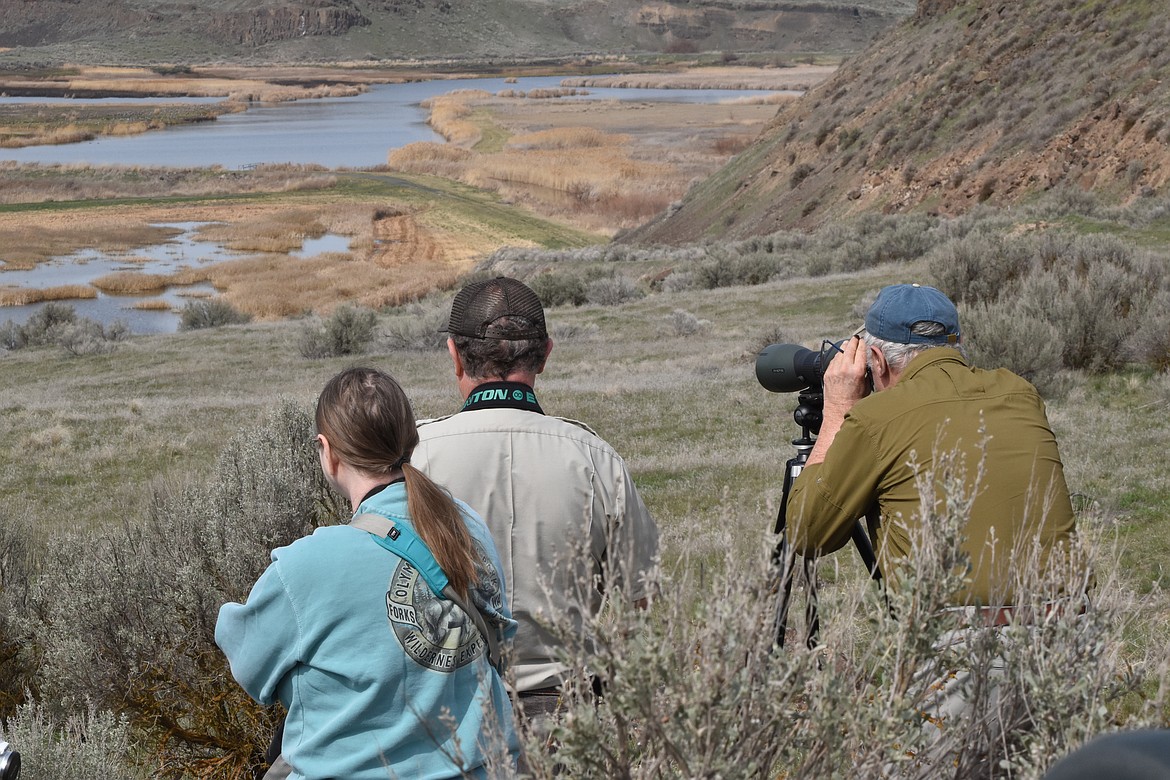 Several visitors to Marsh Unit 1 look to see what kind of wildlife they can spot on March 26.