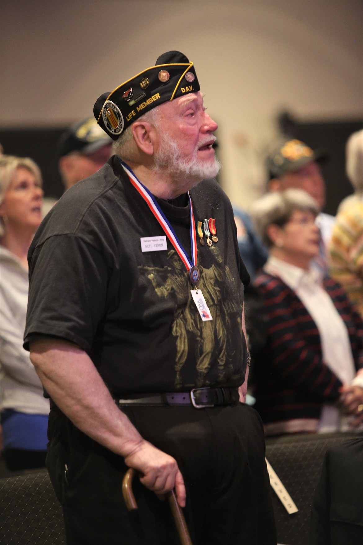 Vietnam War veteran Neil Strom sings the Star Spangled Banner with others at Candlelight Christian Fellowship on Tuesday.
