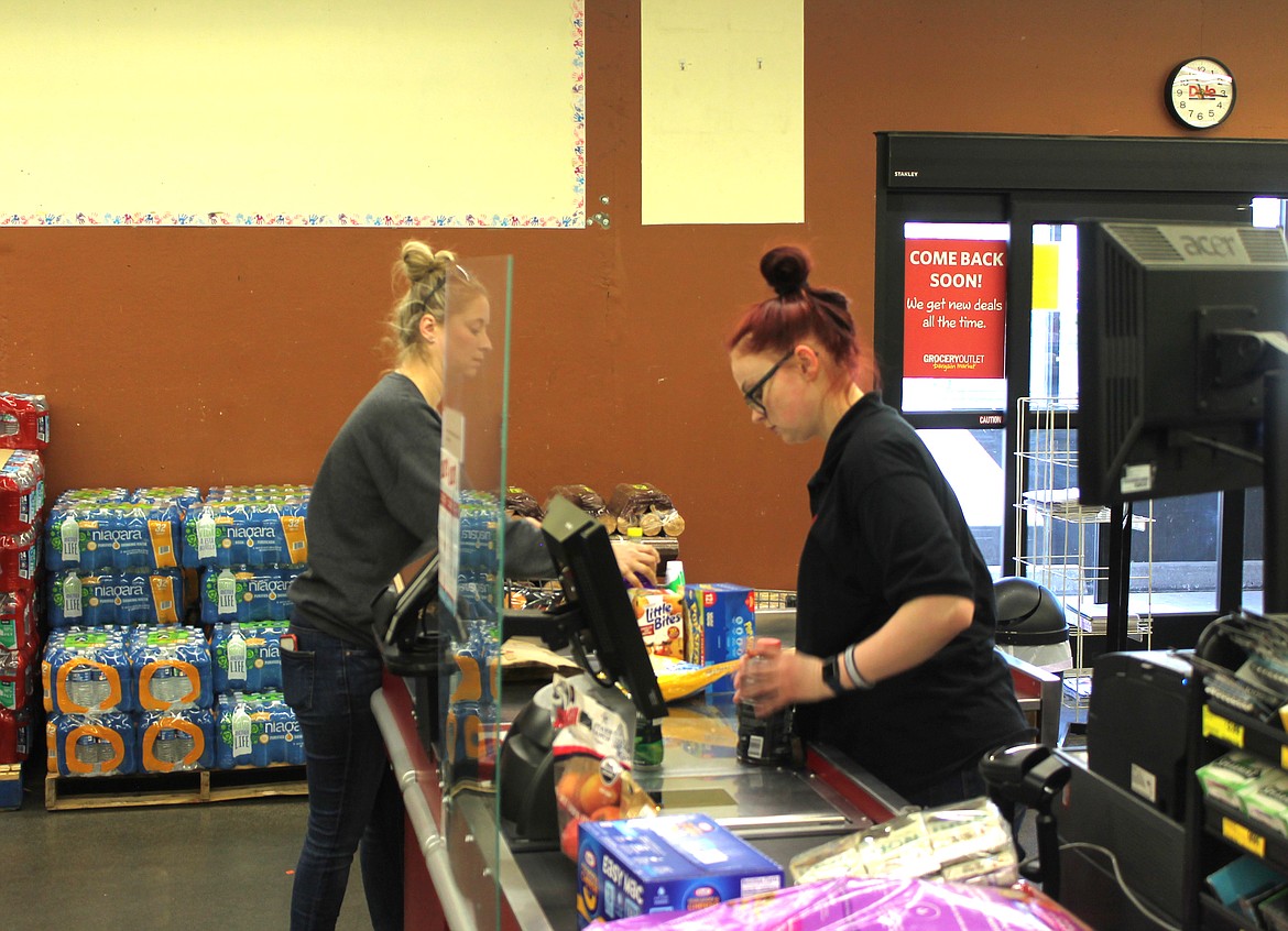 Cierra Harden (right) checks out groceries for Aspen Hagerty of Moses Lake on Tuesday. Harden has only worked for Grocery Outlet Bargain Market for 10 months, but she says it’s her favorite job she’s had so far.