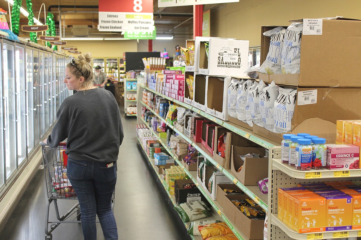 Aspen Hagerty of Moses Lake checks out the frozen food options at Grocery Outlet Bargain Market in Moses Lake Tuesday. The store is celebrating 20 years under the ownership of Kris and Paul Emerson.