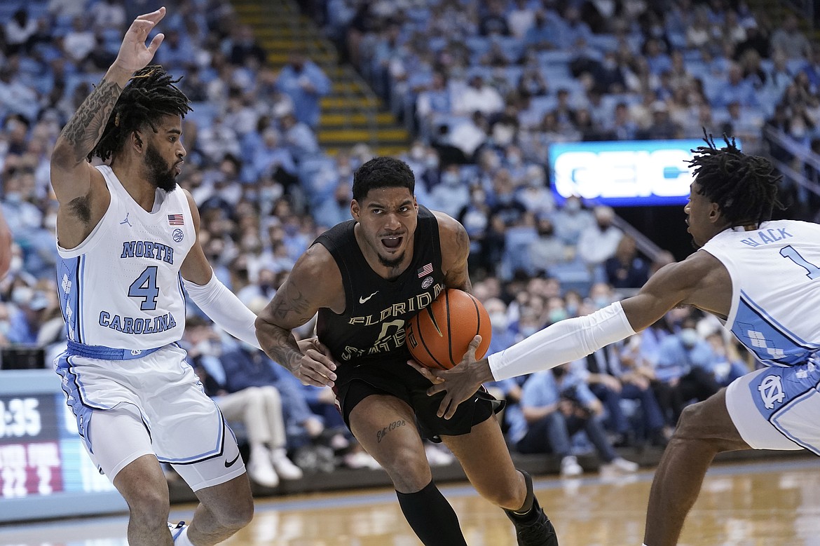 GERRY BROOME/Associated Press
North Carolina guard R.J. Davis (4) and guard Leaky Black (1) guard Florida State guard RayQuan Evans (0) during the second half of a Feb. 12 game in Chapel Hill, N.C. Evans is a former North Idaho College standout.